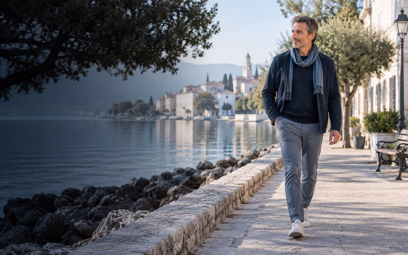 A person walking beside a quiet waterfront